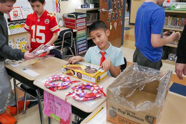 boy selling heart wreaths